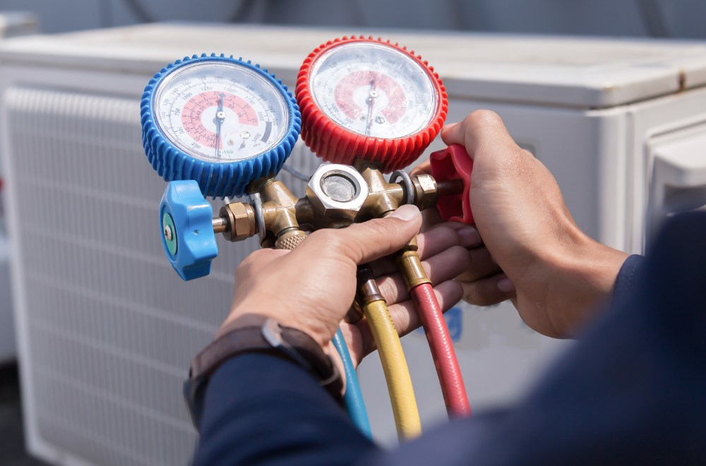 HVAC technician using measuring equipment