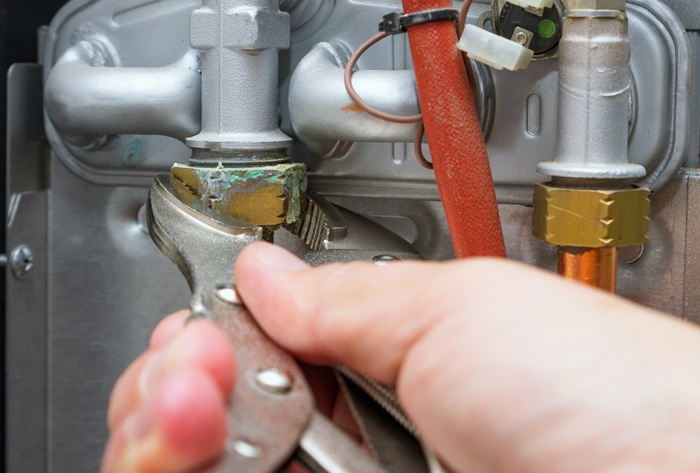 Person fixing leak with tool