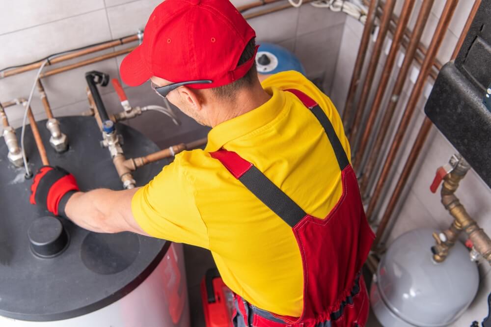 A technician working on a water heater