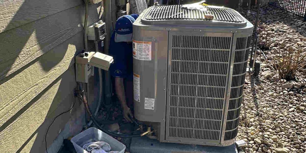 Technician working on an outdoor AC unit