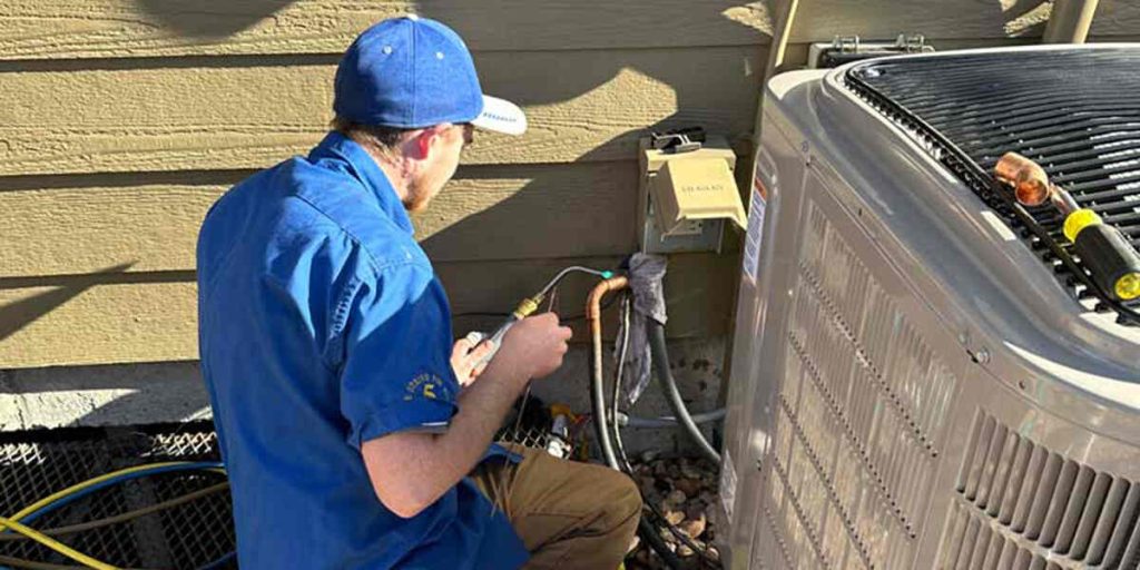 Technician repairing an outdoor AC unit