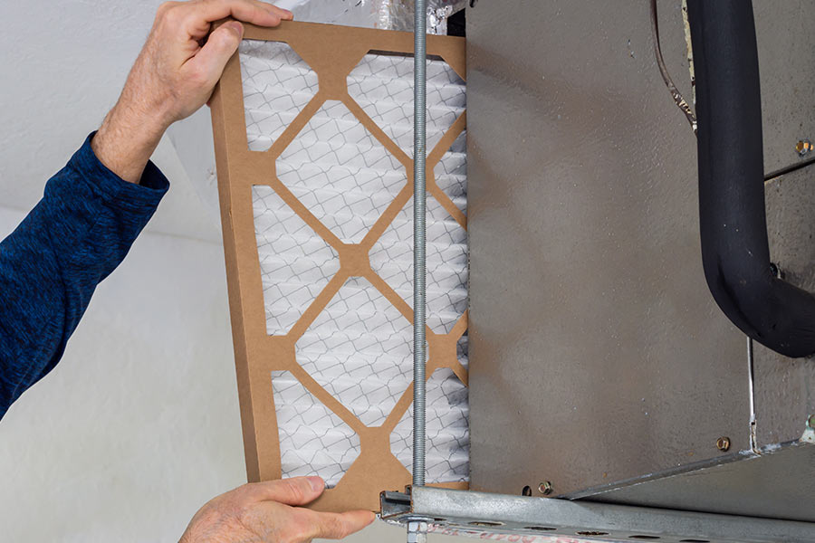 Person changing HVAC filter