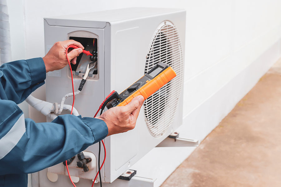 Technician testing HVAC unit